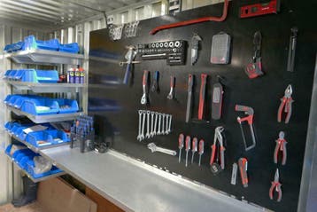 Werkplaats met wandrek - Werkcontainer met stellingen