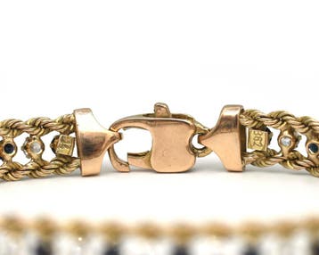 Een 14 krt. geelgouden armband met saffier en zirkonia, Gebruikt
