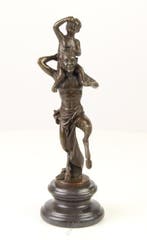 Figuur - A BRONZE SCULPTURE OF A FAUN WITH LITTLE BACCHUS