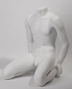 Zittende mannelijke etalagepop zonder hoofd