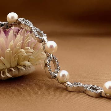 Witgouden infinityschakel armband met parel en zirconia |..., Gebruikt, Ophalen of Verzenden, Met edelsteen, Goud