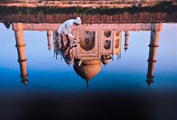 Steve McCurry (1950–) - Reflection of the Taj Mahal in Agra.