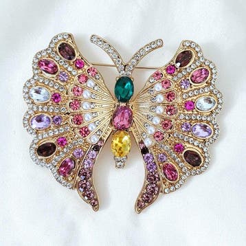 Vintage vlinderbroche van verguld metaal, versierd met