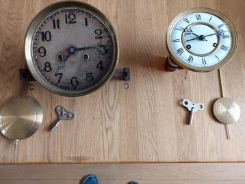 Wandklokken (2) - Metaal - Eerste en tweede helft 20ste eeuw