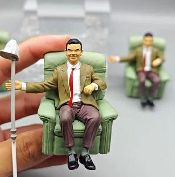 Decoratief ornament - Beeldje van een zittende man in een
