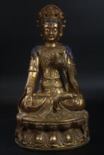 This is a bronze seated statue of Guanyin Bodhisattva. -