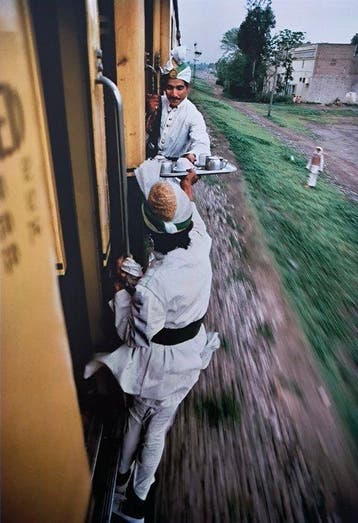 Steve McCurry (1950–) - Breakfast tea passed between train