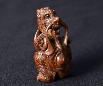 Prachtig antiek Japans houten netsuke - Draak die een gong