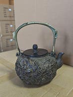 Japanese-style cast iron kettle with embossed dragon design