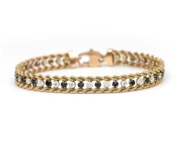 Een 14 krt. geelgouden armband met saffier en zirkonia, Gebruikt